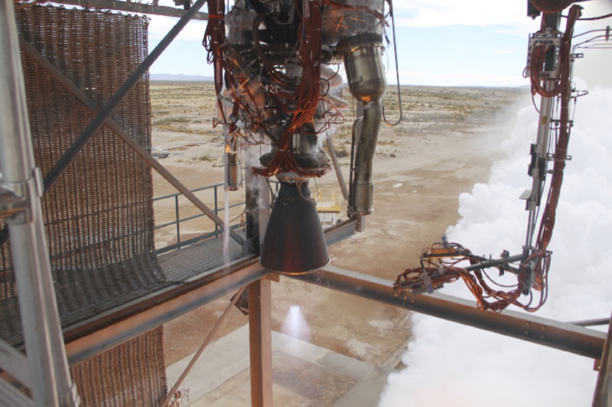 A rocket on the launch pad with liquid oxygen vapor venting in clouds during pre-launch fueling.