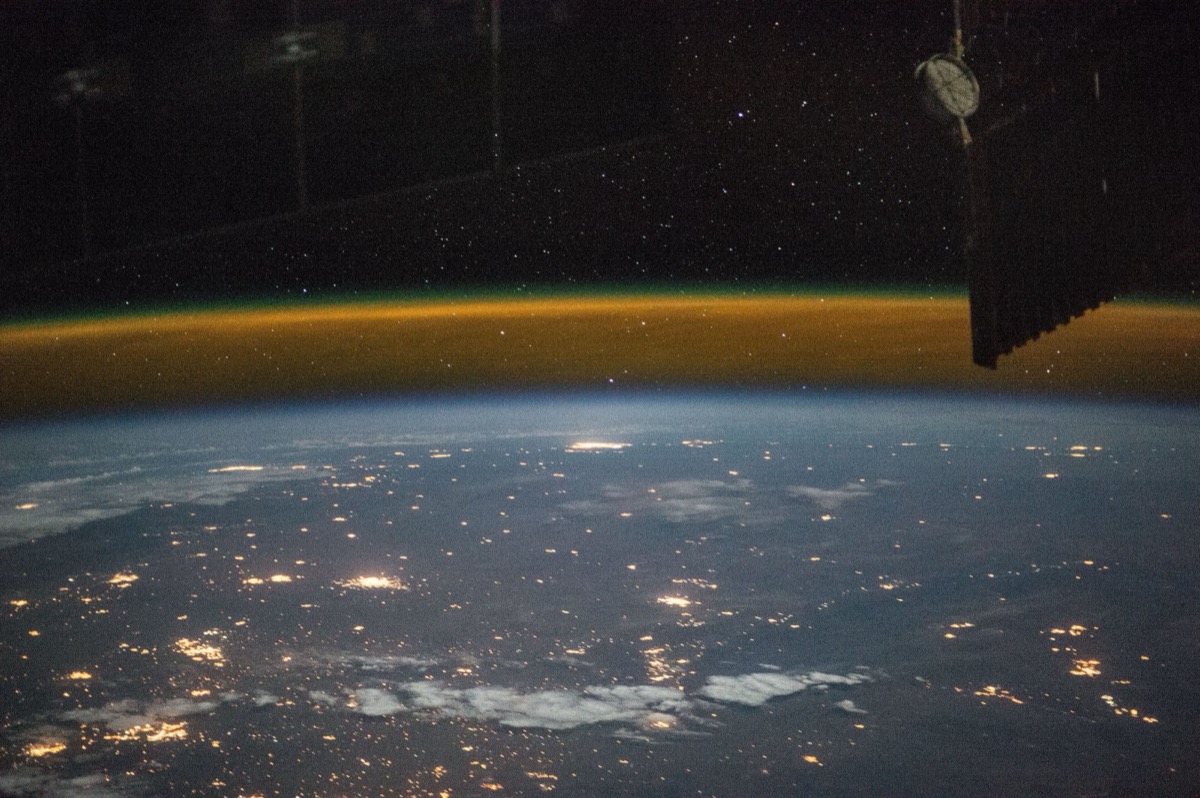 A view from a high-altitude vehicle showing the curvature of Earth and the thin blue atmosphere giving way to black space.