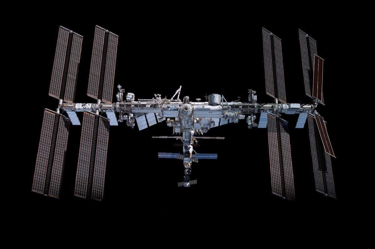 A screenshot of an ISS tracking app showing the station's orbital path and current position over Earth.