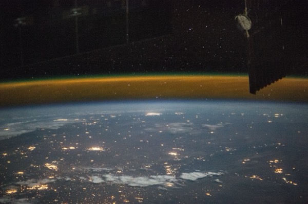 A view from a high-altitude vehicle showing the curvature of Earth and the thin blue atmosphere giving way to black space.